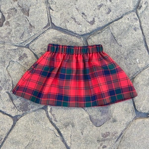 May include: Red, black and green tartan skirt with an elastic waistband.