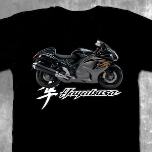 May include: Black t-shirt with a white graphic of a silver and black motorcycle with the text "Hayabusa" in white.