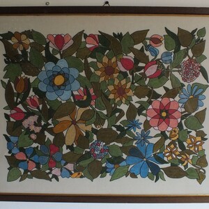 May include: A framed artwork featuring a colourful floral design. The artwork is painted in a stylised manner with various shades of blue, green, yellow, pink, and red. The flowers are arranged in a dense pattern, creating a vibrant and intricate composition.