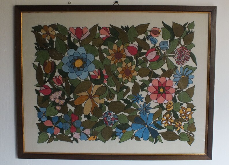 May include: A framed artwork featuring a colourful floral design. The artwork is painted in a stylised manner with various shades of blue, green, yellow, pink, and red. The flowers are arranged in a dense pattern, creating a vibrant and intricate composition.