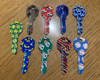 One color house key blank KW1 AXXESS 66 chose from flame, ball, camo, pucks, baseball, happy face ect.