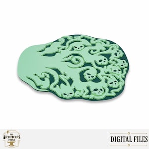 May include: A flat, irregular-shaped decorative piece featuring a dark green base layer topped with a light mint green cutout design. The intricate pattern depicts swirling smoke or vapor clouds interspersed with multiple small, stylized human skulls.