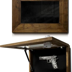 May include: A wooden framed wall-mounted gun safe with a hinged door. The safe is open, revealing a silver handgun with ornate engravings against a black felt interior. The frame has a dark brown finish.