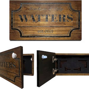 May include: A wooden wall-mounted cabinet with a dark stain, featuring the name "WATTERS" and "est. 2021" engraved. The cabinet door is open, revealing a foam insert with cutouts. The cabinet is designed to hold items.