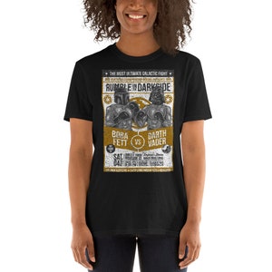 May include: Black t-shirt with a vintage-style poster design featuring a boxing match between Boba Fett and Darth Vader. The poster reads "The Most Ultimate Galactic Fight" and "Rumble in Darkside".