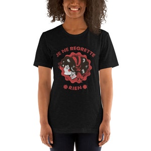 May include: Black t-shirt with a red graphic of a woman's face with the text "JE NE REGRETTE RIEN" in red.