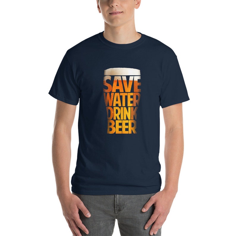 May include: A navy blue t-shirt with a graphic of a beer glass that reads "Save Water Drink Beer".