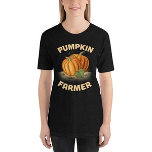 May include: Black t-shirt with a graphic of two pumpkins and the text "Pumpkin Farmer" in a vintage style font.