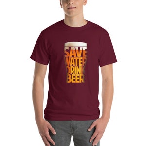 May include: A maroon t-shirt with a graphic of a beer glass with the text "Save Water Drink Beer" printed on it.