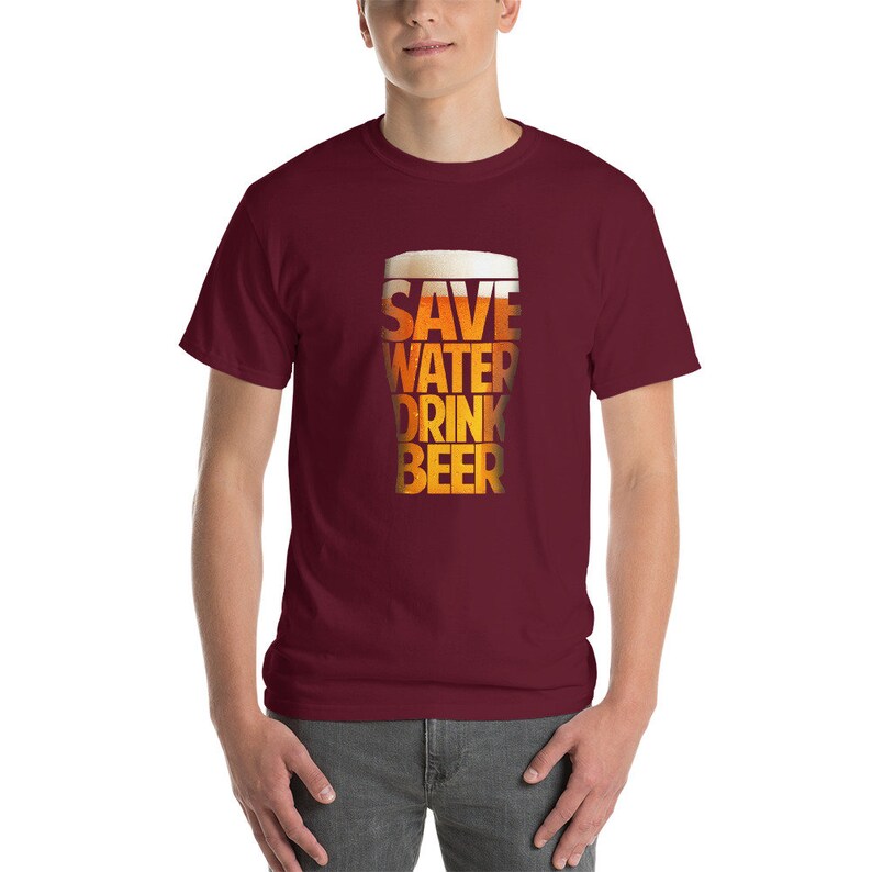 May include: A maroon t-shirt with a graphic of a beer glass with the text "Save Water Drink Beer" printed on it.