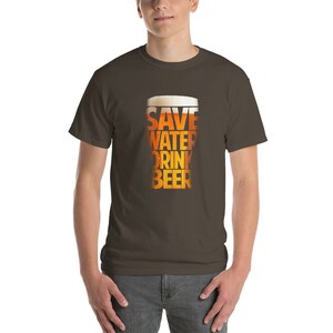 May include: A brown t-shirt with a graphic of a beer glass that says "Save Water Drink Beer".