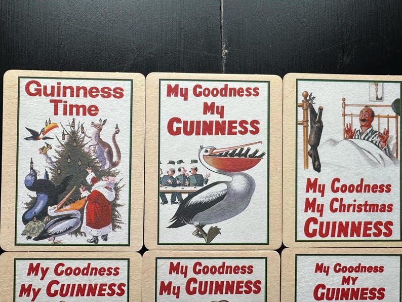 Puede incluir: Un conjunto de tarjetas publicitarias vintage de Guinness. Las tarjetas presentan ilustraciones con texto como "Guinness Time" y "My Goodness My Guinness". Las im&aacute;genes incluyen una escena navide&ntilde;a, un pel&iacute;cano y otros dise&ntilde;os caprichosos.