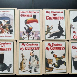 Puede incluir: Un conjunto de tarjetas publicitarias vintage de Guinness. Cada tarjeta presenta ilustraciones coloridas y texto, incluyendo frases como "My Goodness My Guinness" y "A Guinness a Day". Las tarjetas muestran varias escenas caprichosas.