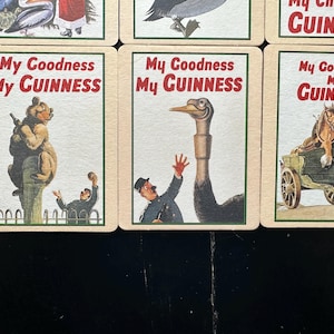 Puede incluir: Una colecci&oacute;n de tarjetas publicitarias vintage de Guinness. Cada tarjeta presenta una ilustraci&oacute;n diferente con el texto "My Goodness My Guinness" en rojo y blanco. Las im&aacute;genes incluyen un oso, un avestruz y un carro tirado por caballos.