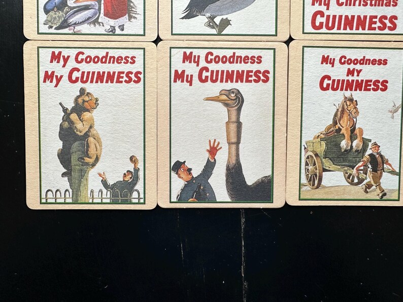 Puede incluir: Una colecci&oacute;n de tarjetas publicitarias vintage de Guinness. Cada tarjeta presenta una ilustraci&oacute;n diferente con el texto "My Goodness My Guinness" en rojo y blanco. Las im&aacute;genes incluyen un oso, un avestruz y un carro tirado por caballos.