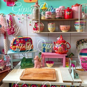 May include: A colorful kitchen scene with decorative items. Includes a crochet bag, a teapot, bowls, jars, and a cutting board. The word "LOVE" is displayed on the wall. The text "Gipsy Queen" is visible in the image.