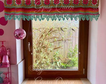 May include: A teal, pink, and yellow crocheted window valance with a scalloped edge. The valance is made with a repeating pattern of flowers. The valance is hanging over a window with a view of a green tree.