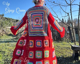 May include: A long, red crochet cardigan with a colorful granny square pattern. The cardigan has a bell sleeve and a scalloped hem. The text "by Gipsy Queen" is visible on the cardigan.