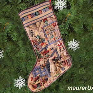 May include: A Christmas stocking with a colorful embroidered design of a toy shop. The stocking is decorated with a red and white striped trim and the letters "A B C E L L" are embroidered on the top.