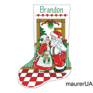 May include: A Christmas stocking with a red and white chequered pattern at the bottom. The stocking features a scene of Santa Claus and Mrs. Claus kissing in front of a doorway with a Christmas tree and mistletoe. The stocking is personalised with the name "Brandon".