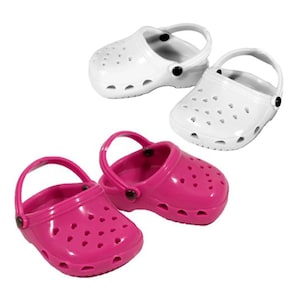 May include: Two pairs of plastic clogs, one pair is white and the other pair is pink.