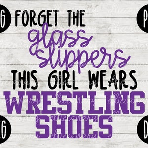May include: Purple text on a white wood background reads "Forget the glass slippers this girl wears wrestling shoes".