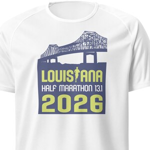 May include: White t-shirt with a blue graphic of a bridge and the text "LOUISIANA HALF MARATHON 13.1 2026"