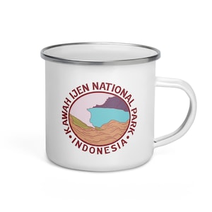 May include: White enamel camping mug featuring a red and brown logo that reads "Kawah Ijen National Park Indonesia". The logo depicts a stylised illustration of a mountain range and a lake.