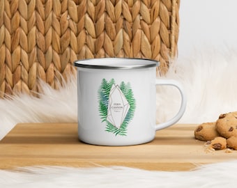 May include: White enamel mug with a silver rim and a design of a geometric crystal with fern leaves and the text "Fern Canyon" in a gold font.