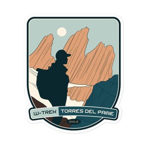 May include: A sticker featuring a silhouette of a hiker with a backpack standing on a mountain peak, with the text "W-Trek Torres del Paine Chile" below. The mountains are depicted in a stylized, graphic style with a blue sky and a white sun.