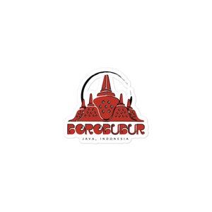 Könnte beinhalten: Ein Aufkleber mit einer roten und schwarzen Illustration des Borobudur-Tempels in Java, Indonesien. Der Text "BOROBUDUR JAVA, INDONESIEN" ist unter dem Bild gedruckt.