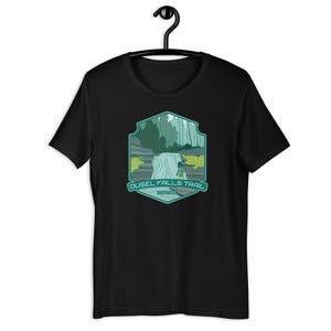 May include: Black t-shirt with a green and white graphic of a waterfall and the text "Ousel Falls Trail Montana".