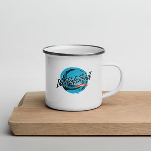 May include: White enamel mug with a blue and black logo that says "Ink Pots Trail Canada".