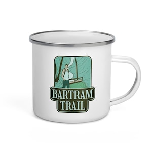 May include: White enamel camping mug with a green and blue illustration of a person hiking on the Bartram Trail. The text "Bartram Trail" is in a green rectangle.