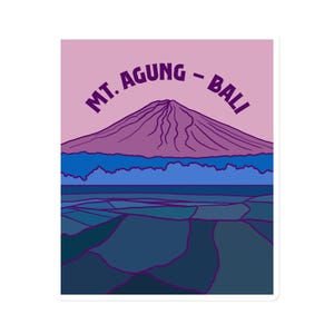 May include: A purple and blue illustration of Mount Agung, a volcano in Bali, Indonesia. The text "MT. AGUNG - BALI" is written in a purple arc above the mountain.
