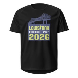 May include: Black t-shirt with a graphic of a bridge and the text "Louisiana Marathon 26.2 2026" in yellow and blue.