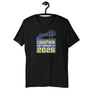 May include: Black t-shirt with a graphic of a bridge and the text "Louisiana Half Marathon 13.1 2026" in yellow.