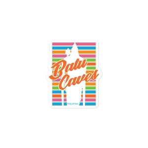 May include: A rectangular sticker featuring the words "Batu Caves" in orange script over a white silhouette of the Batu Caves temple. The background has horizontal stripes in pink, orange, yellow, blue, and green. The word "MALAYSIA" is at the bottom.