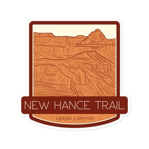 May include: A sticker featuring a line drawing of the Grand Canyon, with the text "NEW HANCE TRAIL" and "GRAND CANYON" in a brown and orange colour scheme.