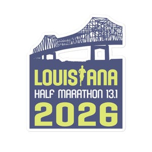 May include: A blue and yellow sticker with a silhouette of a bridge and a runner. The text reads "Louisiana Half Marathon 13.1 2026".