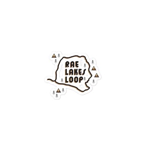May include: A white sticker with a brown outline of a trail loop and the text "Rae Lakes Loop" in black. The sticker is surrounded by small brown triangle shapes.