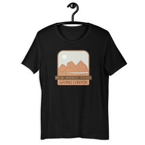 May include: Black t-shirt featuring a brown graphic of a mountain range and the text "New Hance Trail Grand Canyon".