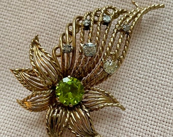 A vintage peridot and diamond brooch/pendant
