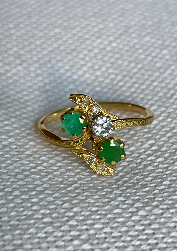 An 18 karat French diamond and emerald toi et moi 