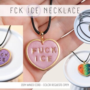 May include: Heart-shaped pendant necklaces with the text "FUCK ICE". The pendants are in various colors, including pink, purple, and a rainbow gradient, with gold-colored trim. Each necklace has a black cord. The text "FCK ICE NECKLACE" is at the top.