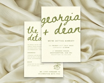 May include: Two cream-colored wedding invitation cards with olive green text. The front card features the names Georgia + Dean in a handwritten script, followed by event details including the date Friday 11th July 2025 and location Orange House.