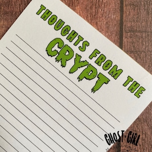 May include: A white lined notepad with the text "Thoughts from the Crypt" in green letters with a dripping effect. The text "Ghost Girl Greetings" is in the bottom right corner.