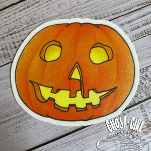 May include: A bright orange pumpkin with a carved jack-o'-lantern face. The pumpkin has a yellow smile, triangle nose, and two round eyes. The eyes are outlined in black and have a yellow glow.