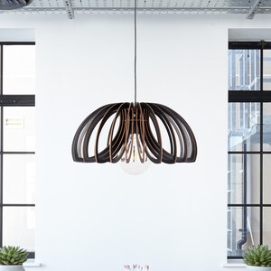 May include: A white table with six gray chairs and a wooden slat pendant light hanging above it. The table is set in a modern office space with large windows and a wood floor.
