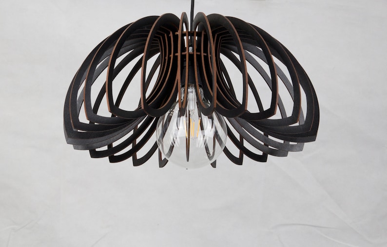 May include: A black wooden pendant light fixture with a geometric design. The light fixture has a clear glass globe and a single light bulb.